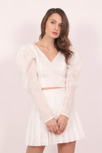 White embroidered cotton top with oversized sleeves.