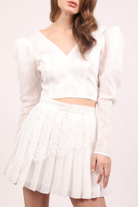 White embroidered cotton top with oversized sleeves.